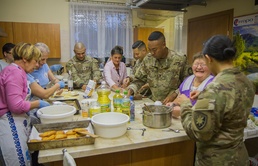 50th Regional Support Group Soldiers prepare meal with locals in Poland