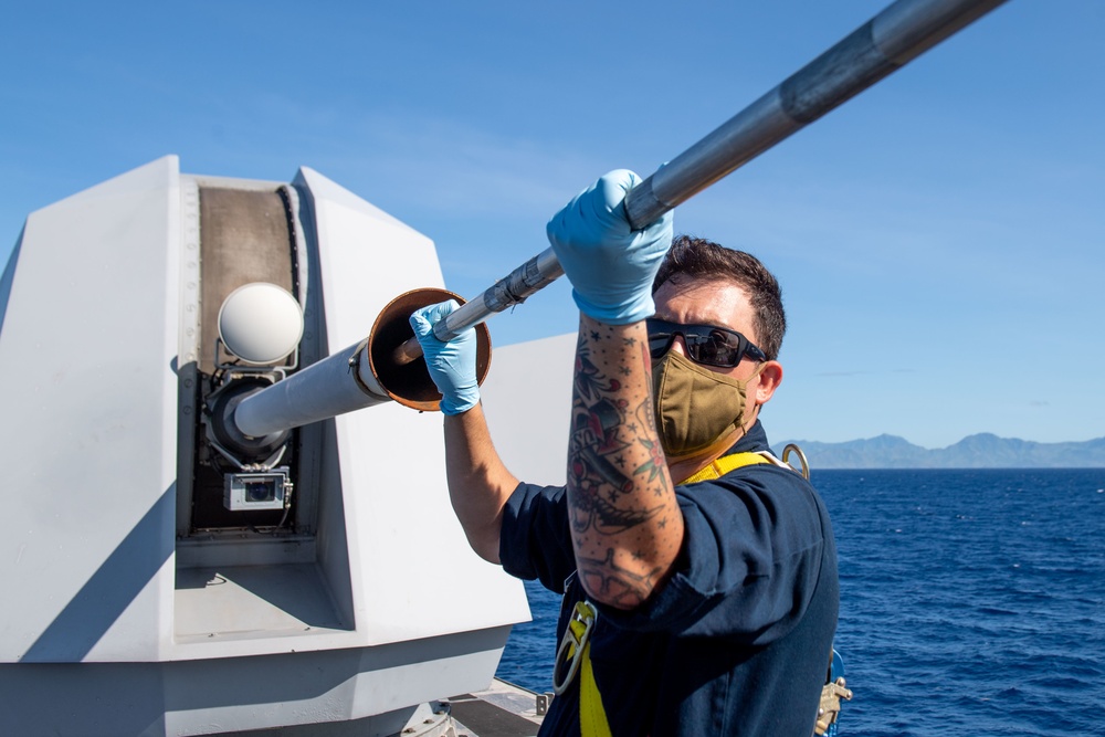 USS Sailors Conduct Maintenance on a 57mm Mark 110
