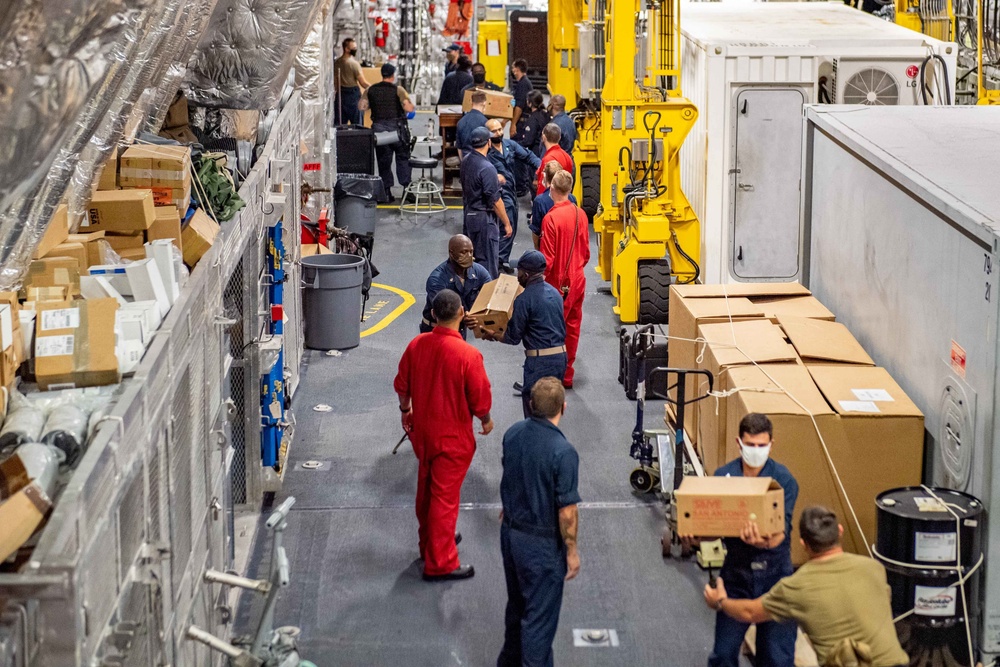 USS Charleston Sailors Onload Supplies