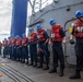 Sailors aboard the USS Dewey Heave a Phone and Distance Line during a Replenishment-at-sea