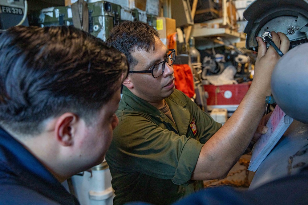 AO1 Joshua Leija and PR2 Charles Kiggins Conduct Preventive Maintenance on an MH-60R Helicopter