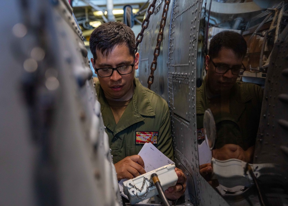 AO1 Joshua Leija Conducts a Preventive Maintenance Check on an MH-60R Helicopter