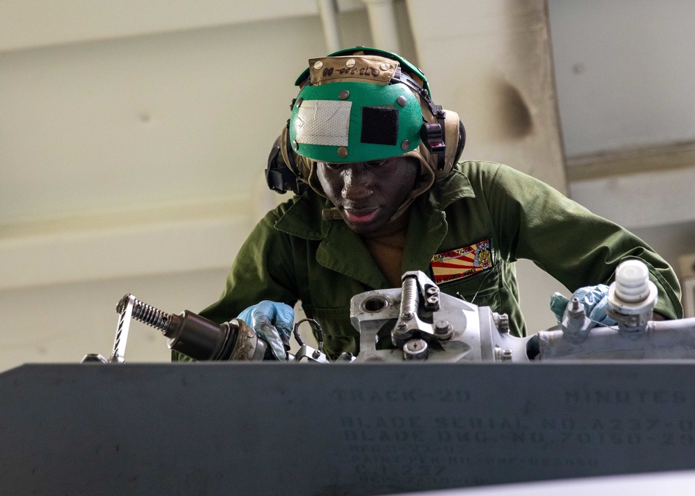 Airman Ousainou Jammeh Conducts Preventive Maintenence on an MH-60R Helicopter