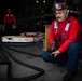 USS Sioux City Sailor Tests for Extinguishing Agent During a Flight Deck Fire Drill