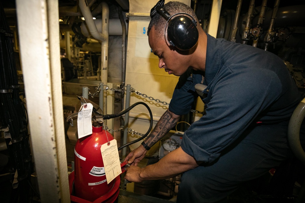 USS Sioux City Sailor Secures a CO2 Bottle in the Main Machinery Room During MOB-E Drill