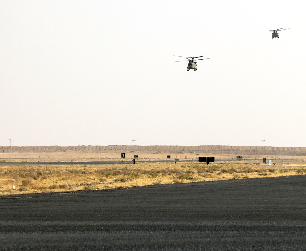 Chinook helicopters from C Co, 1-171 Aviation Regiment land at Camp Buehring
