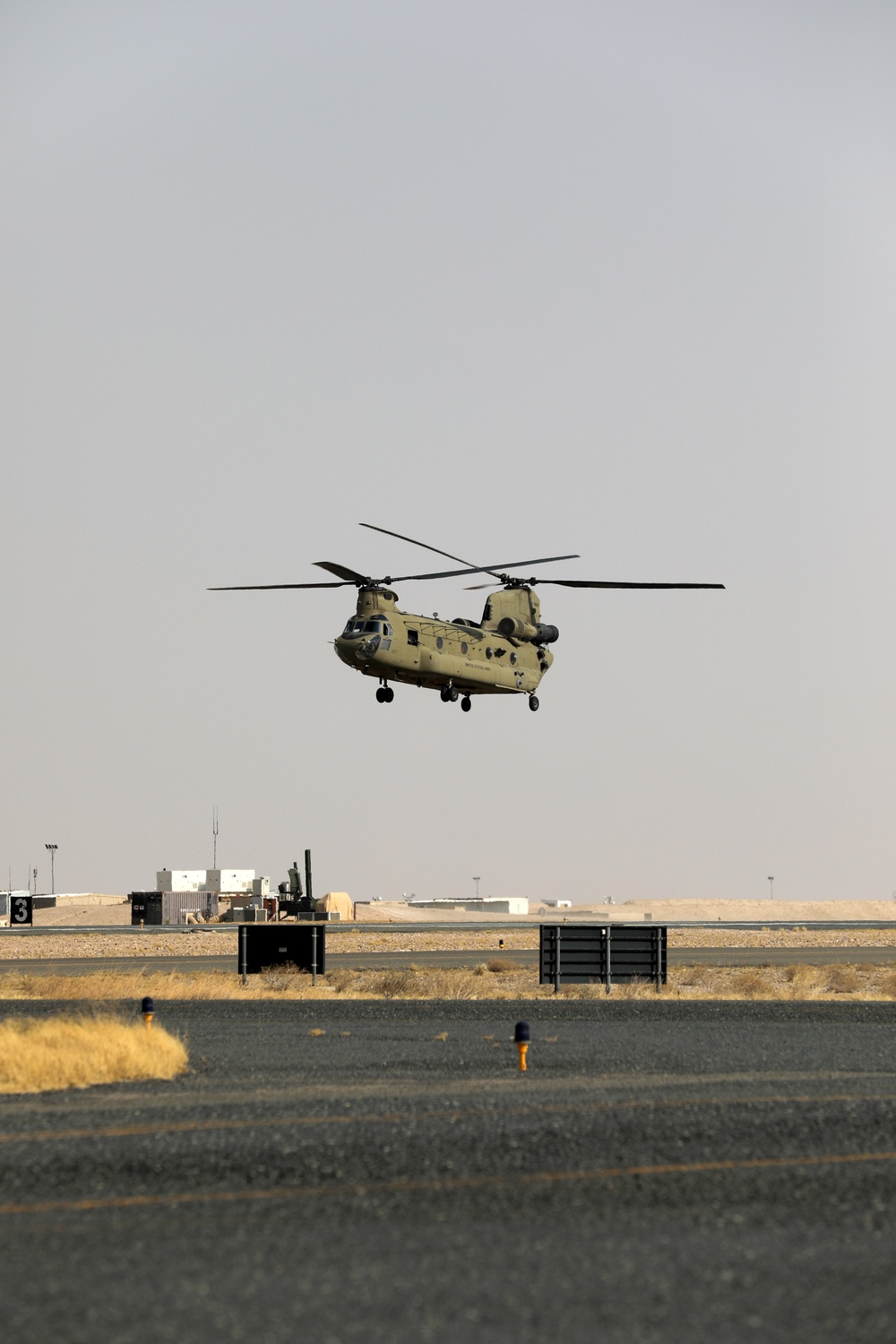 Chinook helicopters from C Co, 1-171 Aviation Regiment land at Camp Buehring