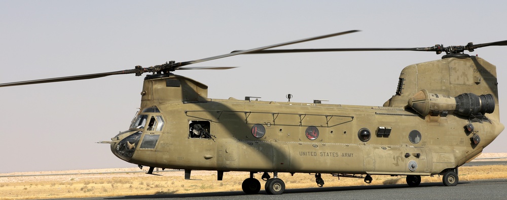Chinook helicopters from C Co, 1-171 Aviation Regiment land at Camp Buehring