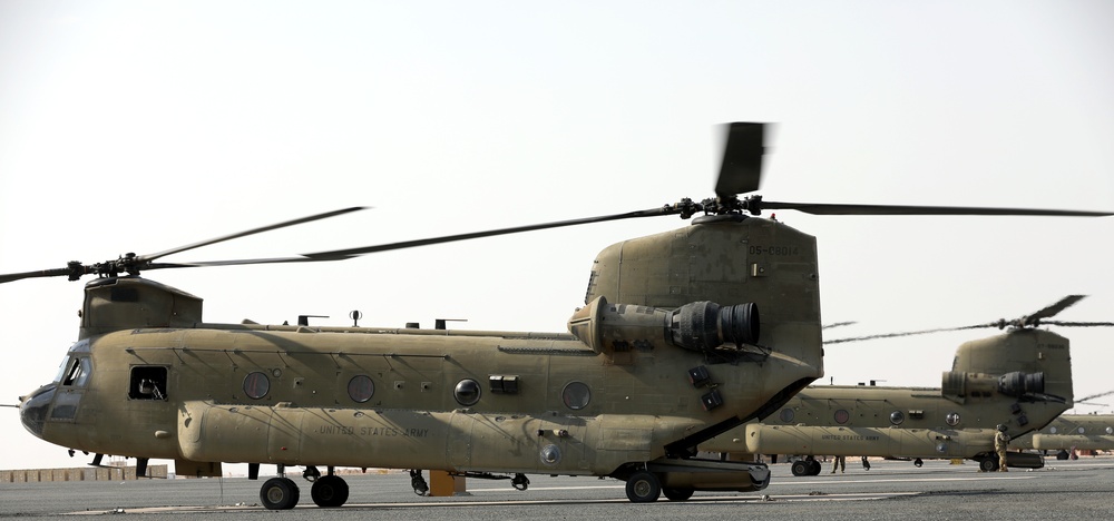 Chinook helicopters from C Co, 1-171 Aviation Regiment land at Camp Buehring