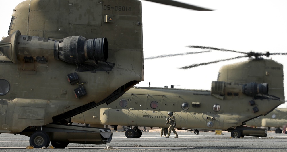Chinook helicopters from C Co, 1-171 Aviation Regiment land at Camp Buehring