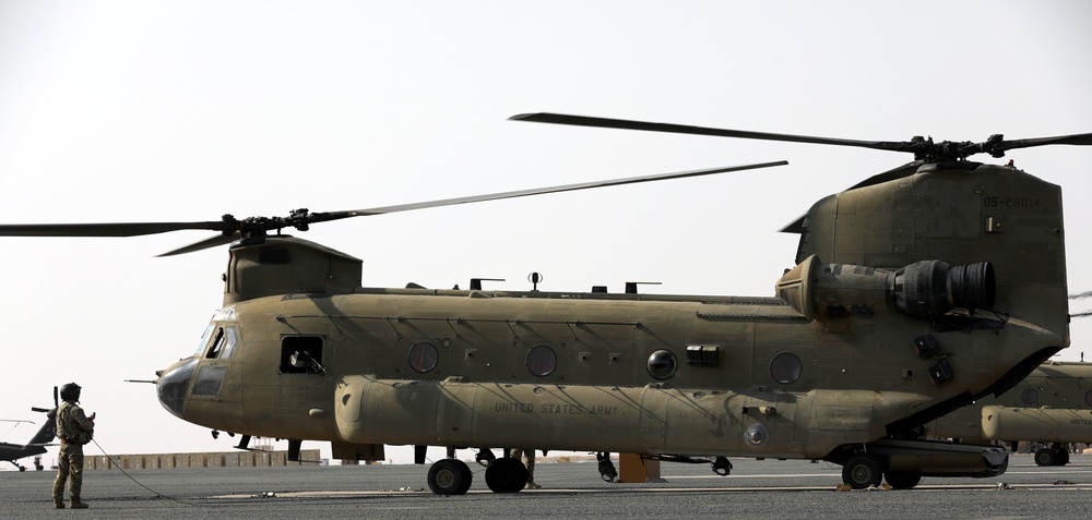 Chinook helicopters from C Co, 1-171 Aviation Regiment land at Camp Buehring