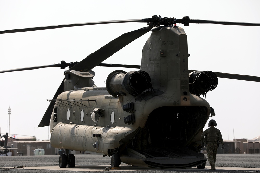 Chinook helicopters from C Co, 1-171 Aviation Regiment land at Camp Buehring