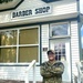 Navy Barber Poses Outside Vintage Barber Shop