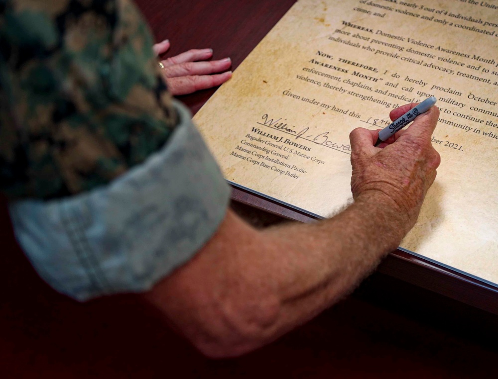 The Commanding General of MCIPAC signs Domestic Violence Awareness Month Proclamation