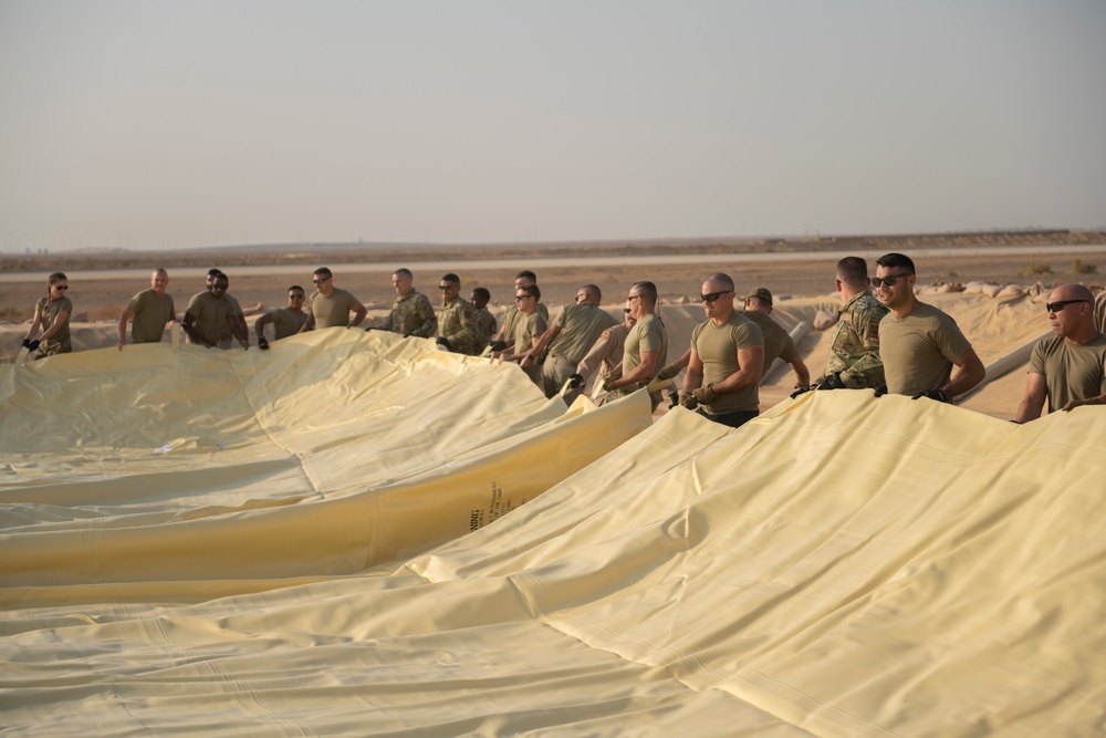 332nd AEW Airmen layout collapsible fabric tank