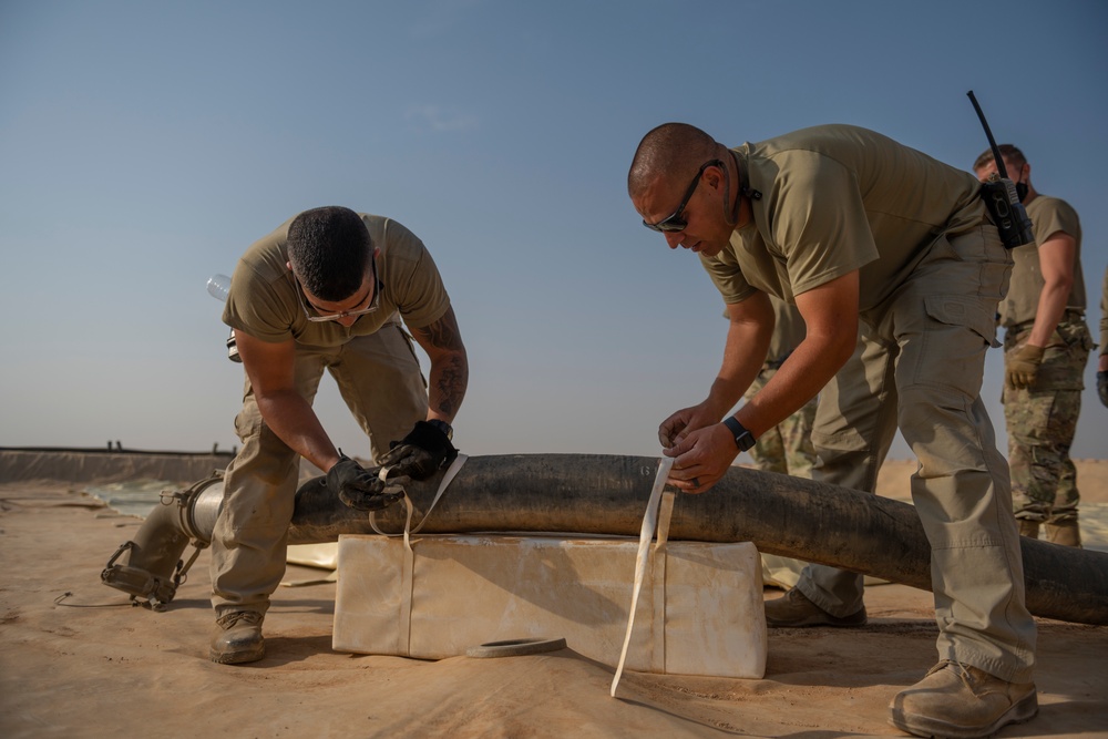 332nd AEW Airmen layout collapsible fabric tank