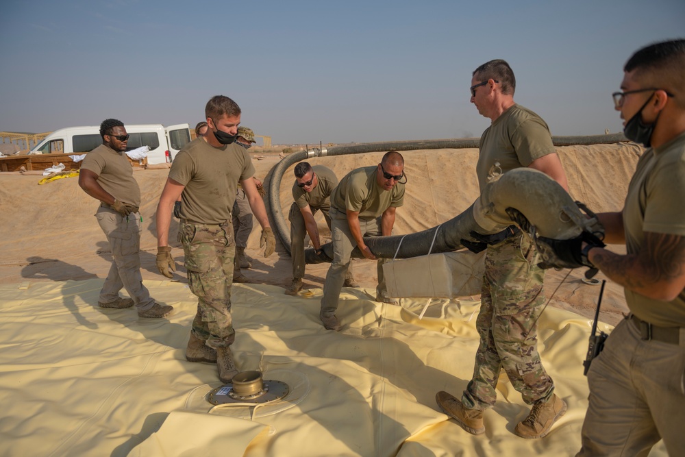 332nd AEW Airmen layout collapsible fabric tank