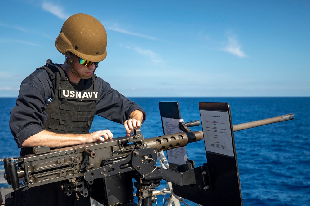 USS Billings Sailor Examines a .50-Caliber Machine Gun During Live-Fire Exercise