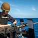 USS Billings Sailor Examines a .50-Caliber Machine Gun During Live-Fire Exercise