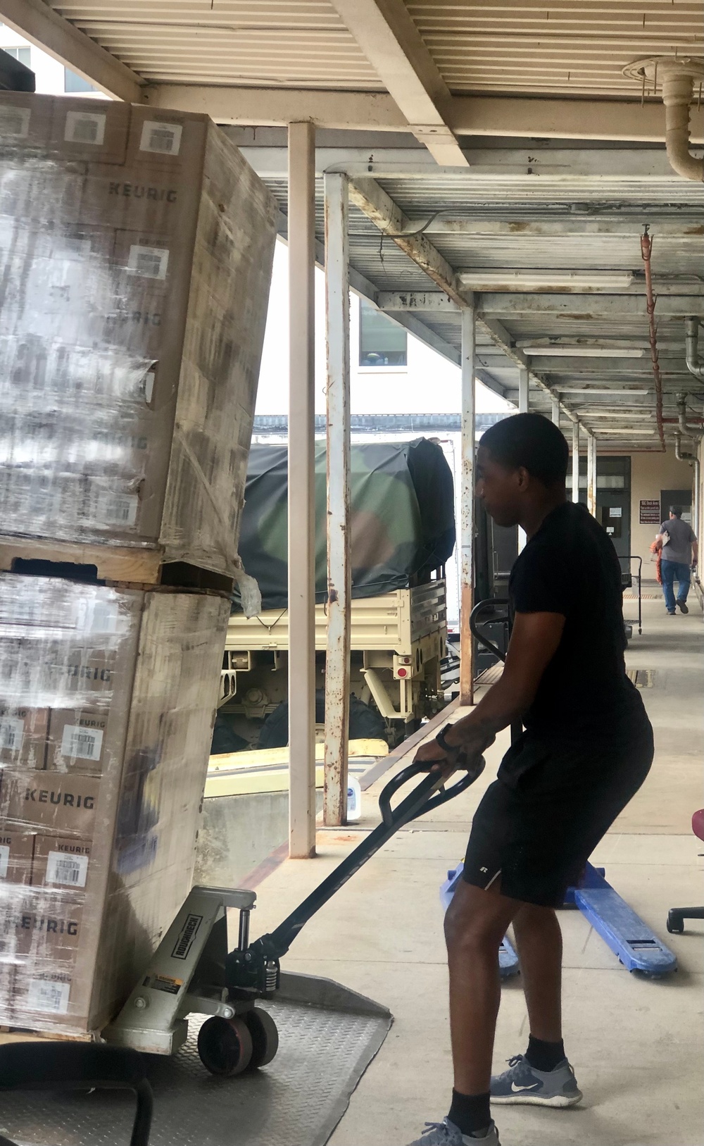 Spc. Andre Thomas helps move pallets