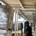 Spc. Andre Thomas helps move pallets