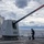 OS2 Brandon Pratt Sweeps the Foc'sle during a Fresh water Wash-down Aboard USS Dewey