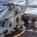 Sailors aboard USS Dewey Refuel an MH-60R Helicopter assigned to HSM-51