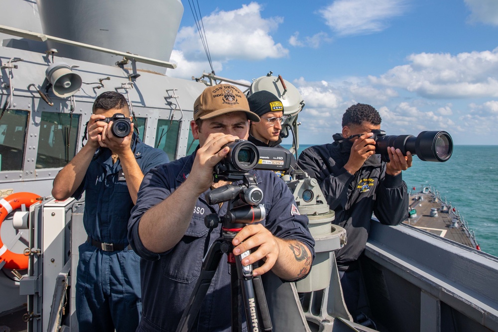 Sailors on the Bridge Wing of USS Dewey Conduct Visual Information Collection