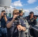Sailors on the Bridge Wing of USS Dewey Conduct Visual Information Collection