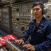 EM2 Ace Tapit Mans the Port Shaft Control Console in the Engine Room aboard USS Dewey