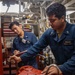 EM2 Martin Escobar Conducts Preventative Maintenance in the Engine Room aboard USS Dewey
