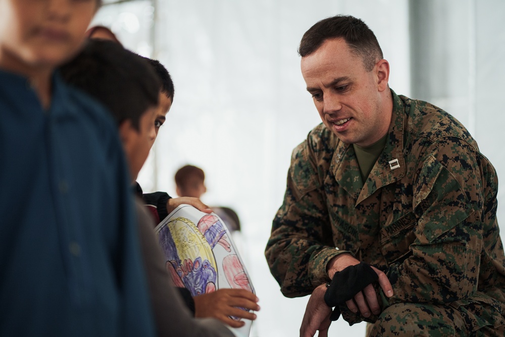 Task Force Pickett personnel read books to Afghan children
