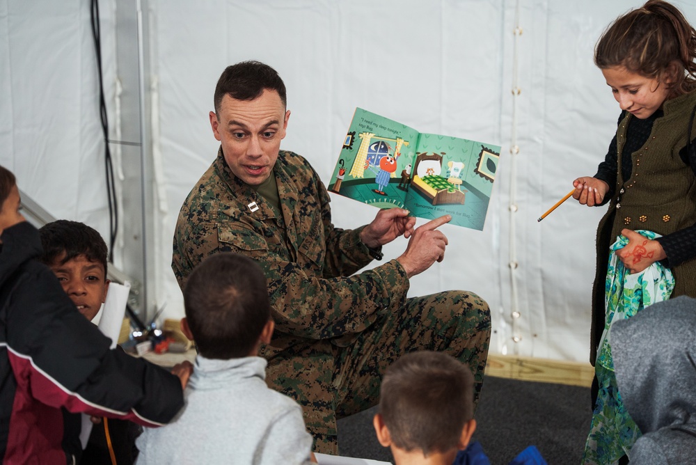Task Force Pickett personnel read books to Afghan children