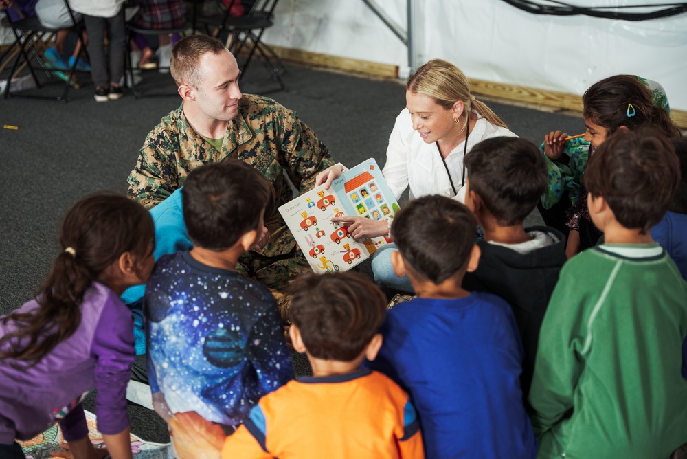 Task Force Pickett personnel read books to Afghan children