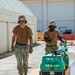 US Navy Seabees assigned to NMCB-5 place asphalt onboard Camp Shields