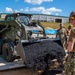 US Navy Seabees assigned to NMCB-5 place asphalt onboard Camp Shields