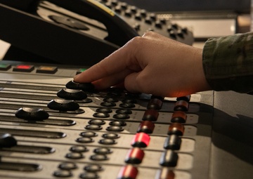 AFN Kaiserslautern radio DJ adjusts levels on board