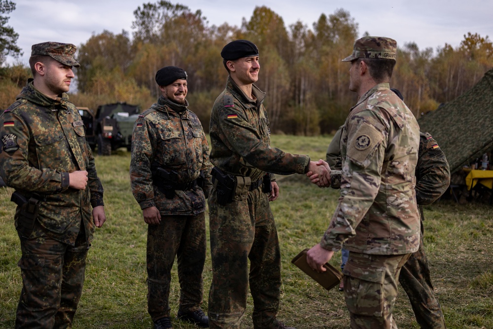 U.S. Army Cpt. Shakes Hands With Visiting German Soldiers