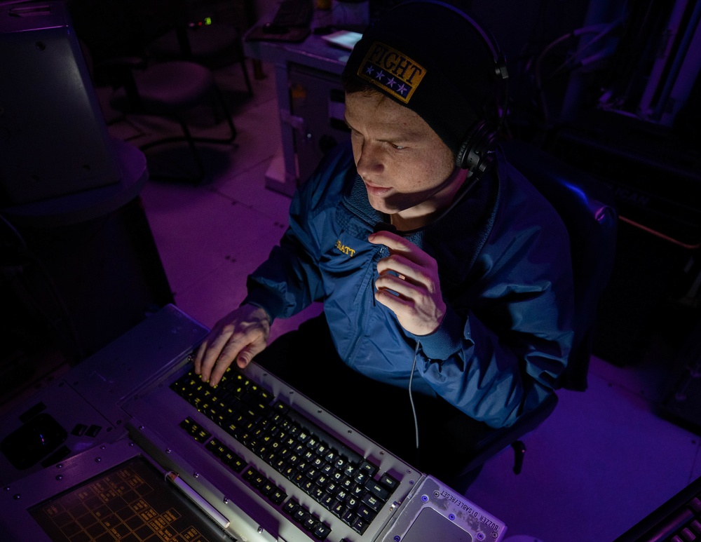 OS2 Brandon Pratt Stands Watch in the Combat Information Center aboard USS Dewey