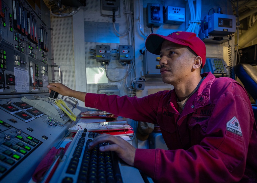 MR2 Shawn McDew Mans the Propulsion and Auxillary Control Console in the Central Control Station aboard USS Dewey