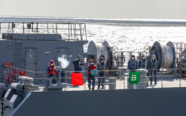 JMSDF Sailors aboard the JS Omi Fire a Shot Line to USS Dewey