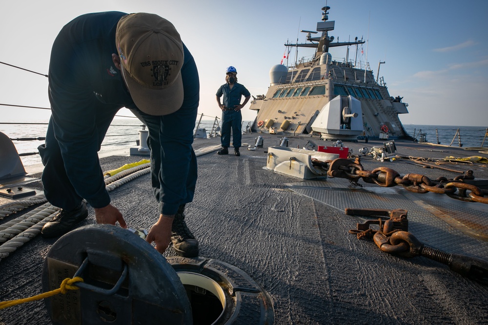 USS Sioux City Sailor Prepares to Pull a Line on Deck During Sea and Anchor Detail