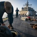 USS Sioux City Sailor Prepares to Pull a Line on Deck During Sea and Anchor Detail