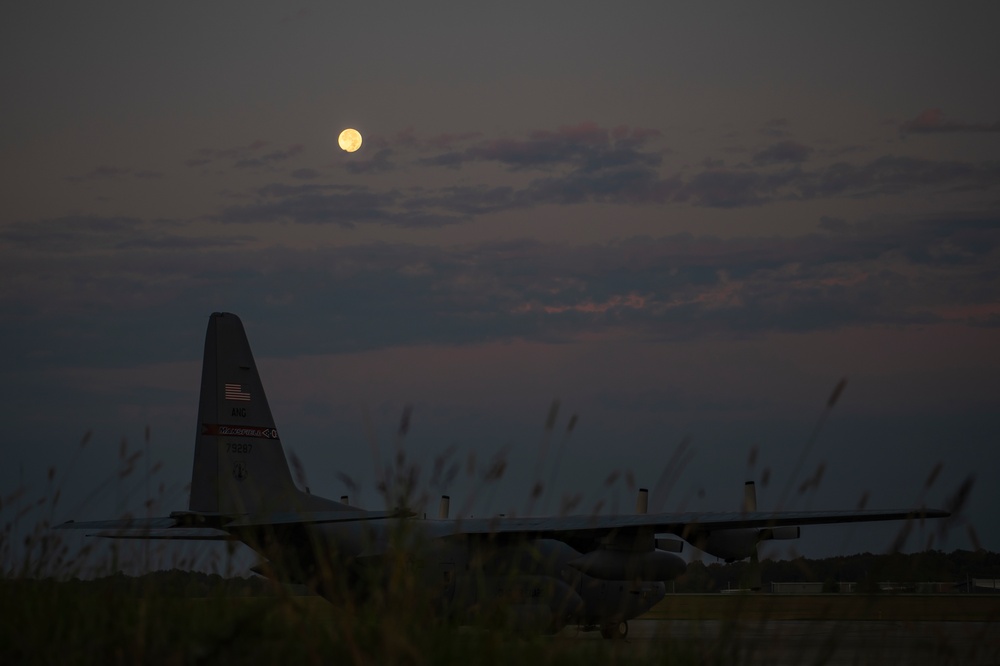 Hunters Moon sets over C-130H Hercules