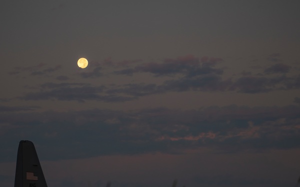 Hunters Moon sets over C-130H Hercules