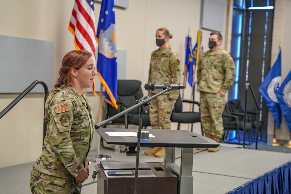 Airman sings the national anthem for the SIPRNet mission transfer