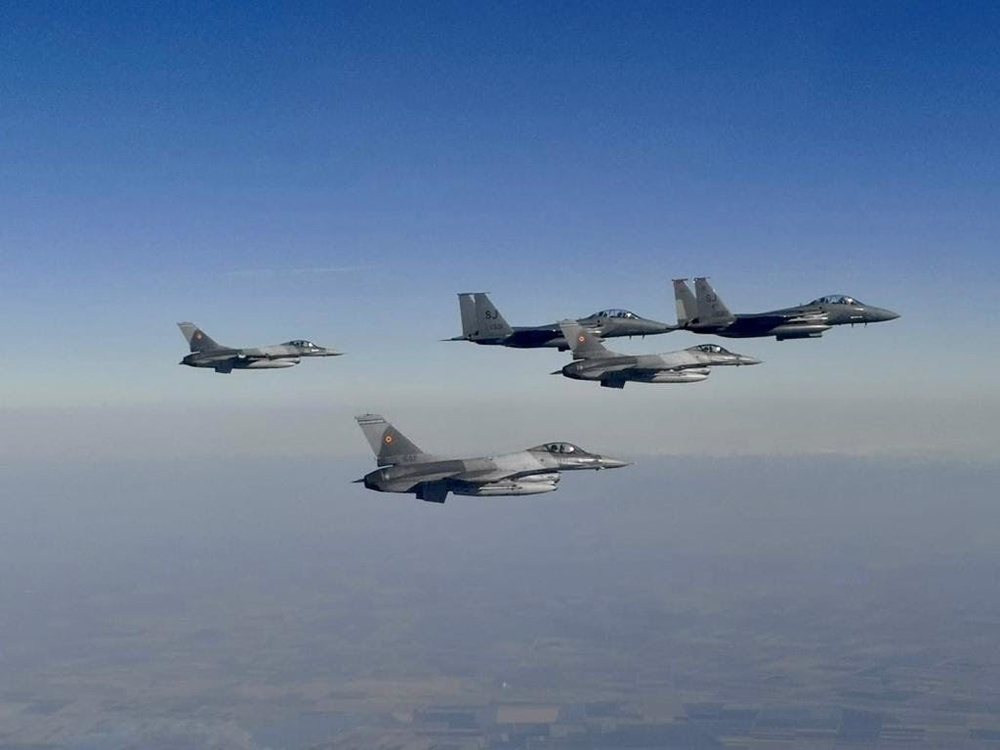 F-15E Strike Eagles fly alongside Romanian F-16s during Castle Forge