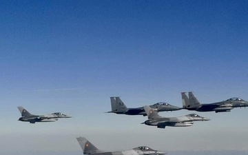 F-15E Strike Eagles fly alongside Romanian F-16s during Castle Forge