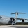 A U.S. Air Force C-17 Globemaster III military transport aircraft is parked on a tarmac under clear blue skies. The aircraft bears tail number 6165 and markings for the 436th Airlift Wing and 512th Airlift Wing. The setting appears to be a military airfield, likely Dover Air Force Base, Delaware, based on the unit designations.