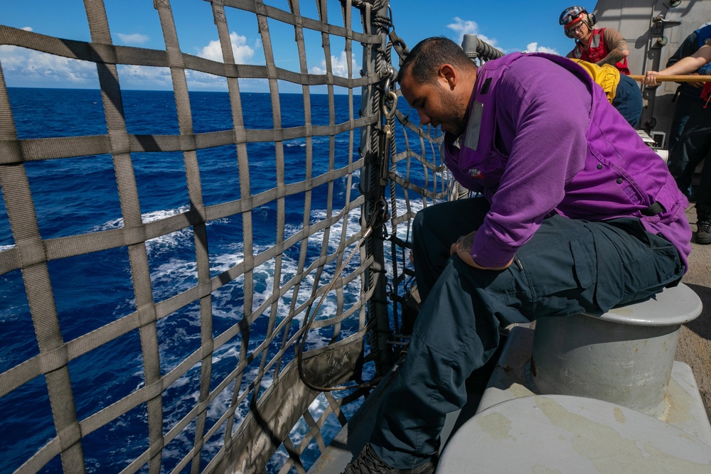 USS Sioux City Sailor Prepares to Lower Flight Deck Nets During Flight Ops